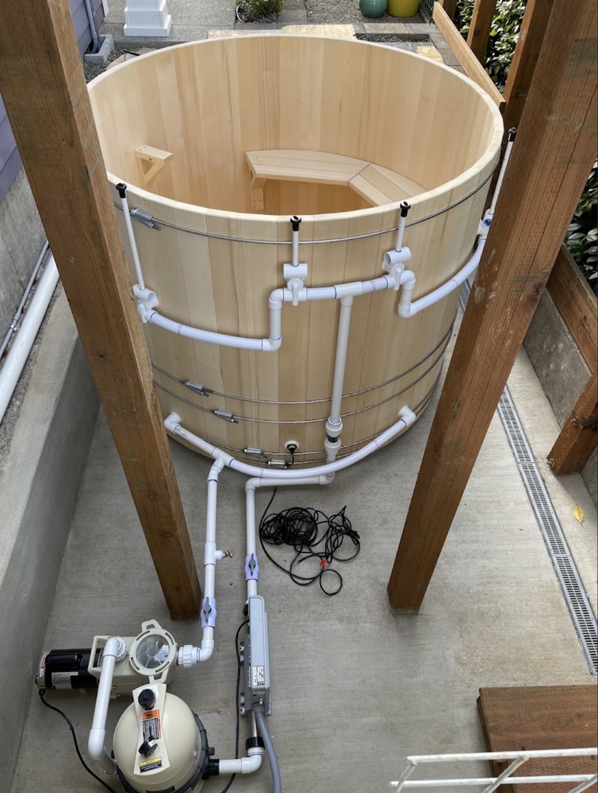 Custom cedar hot tub built with All Out Plumbing's manifold and pump system